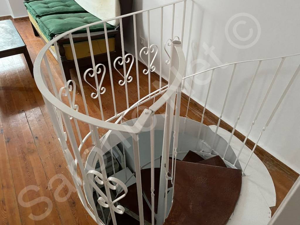 Spiral stairs down to bedroom 1