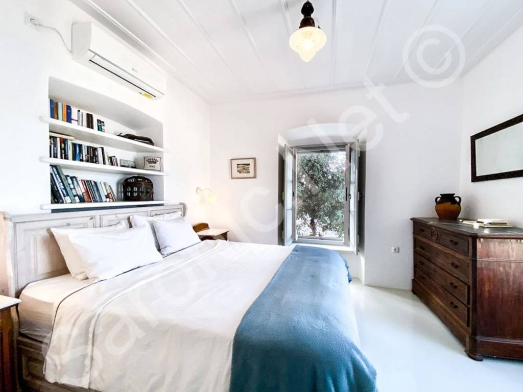 Master bedroom with dual aspect windows and views.