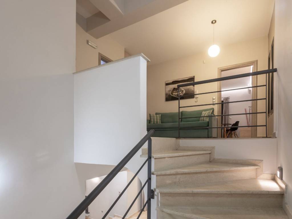 Marble stairs up to 1st floor landing with sitting area.