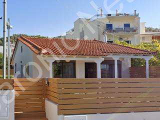 Pool House, fenced property with terracotta tiled roof.