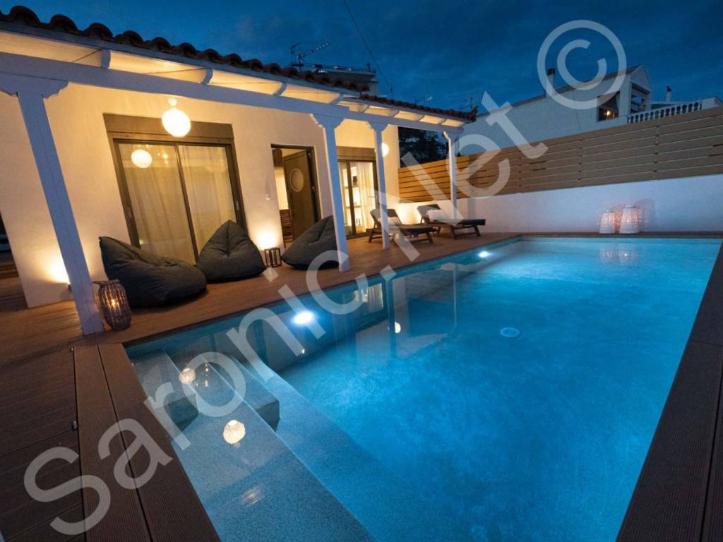 Well lit, fenced terraced area and large pool with steps.