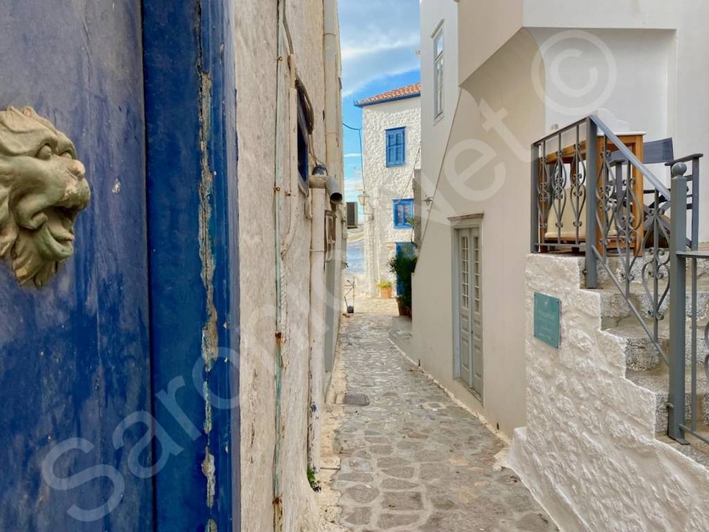 Side street entrances, blue door to residential top floor