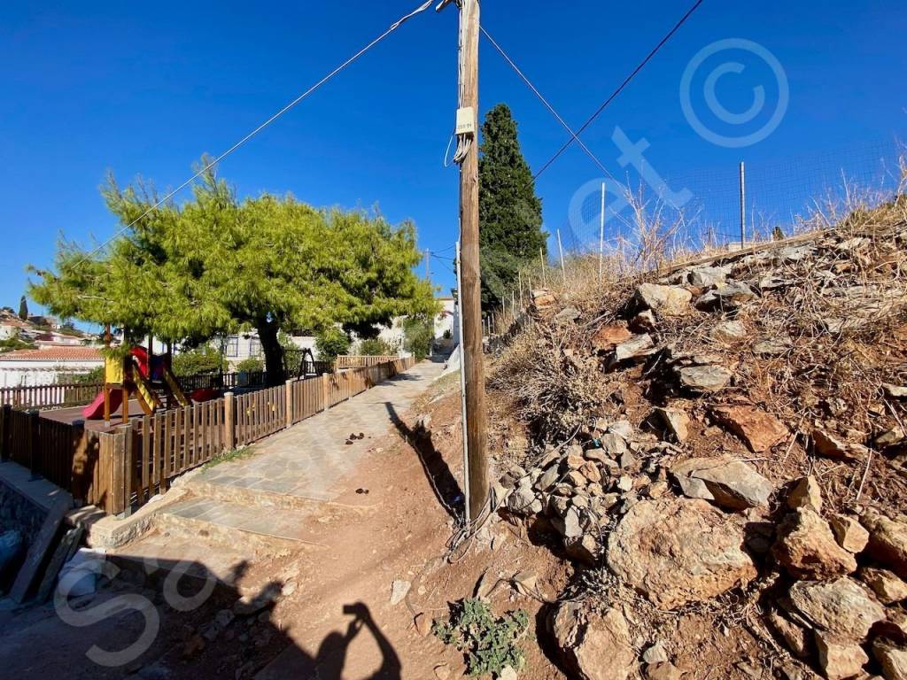 Cables for utilities across street and land next to plot.