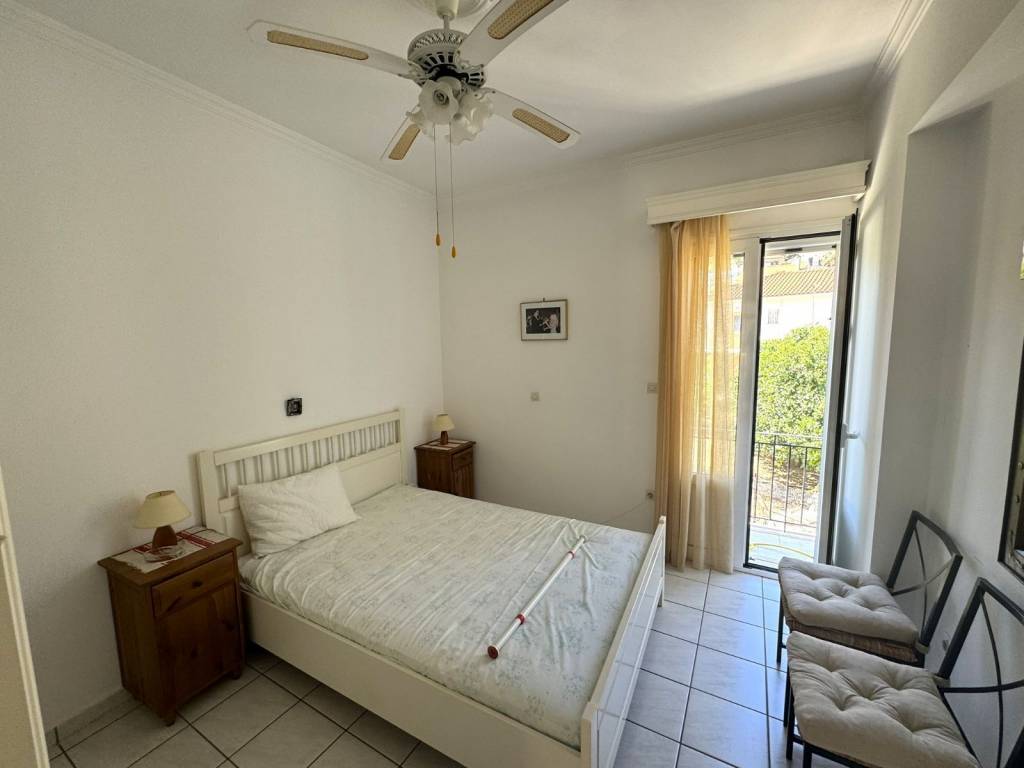 Double bedroom with ceiling fan and balcony door