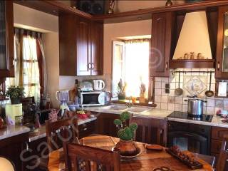 Fitted kitchen overlooks the west side terrace