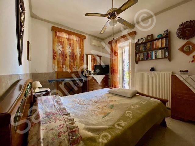 Master bedroom with window and doors to terrace.
