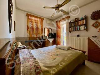 Master bedroom with window and doors to terrace.
