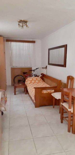 Sleeping area in studio of apartment on lower floor.