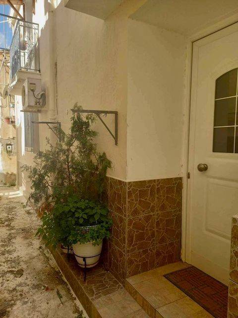 Side street of Poros with main front entrance to apartment.