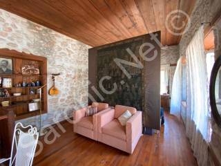 Virani divided by hanging tapestry screening master bed