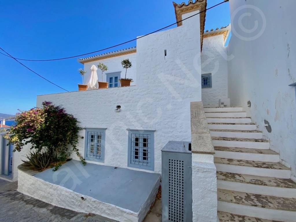 Guest stairs to top level living space off entrance balcony.