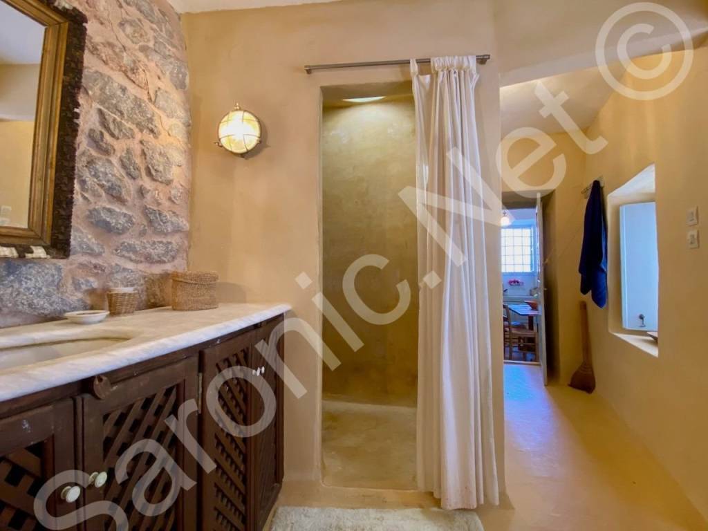 Shower with skylight, washing machine under sink.